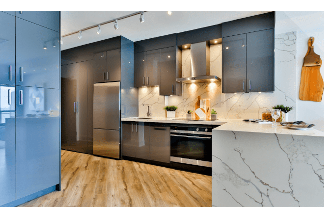 A modern kitchen features glossy gray cabinets, stainless steel appliances, and white marble countertops and backsplash.
