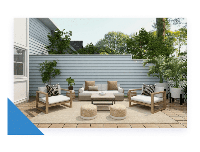 An outdoor patio with light wood furniture, white cushions, and potted plants on a wooden deck.