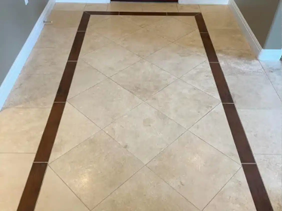 Light beige diamond-patterned floor tiles are bordered by a dark brown rectangular frame.
