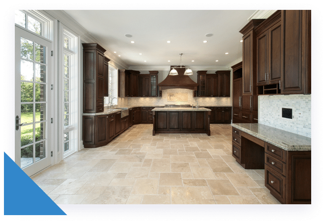 A spacious kitchen with dark wood cabinets, light tiled floors, a large island, and a glass-paned door.